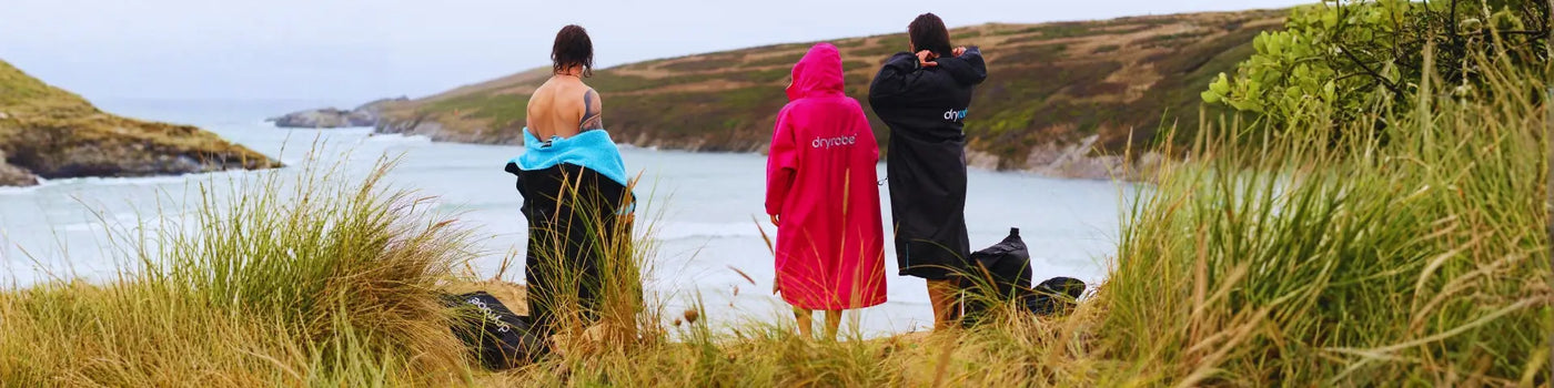 Blue and yellow waterproof Dryrobe rain poncho with hood